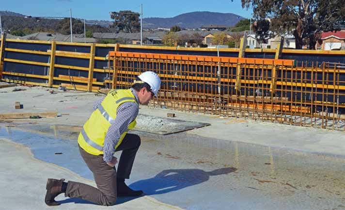 worker looking at quality of concrete